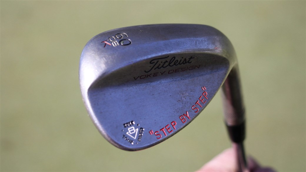 Webb Simpson's Vokey protoype lob wedge, stamped with 'STEP BY STEP'.