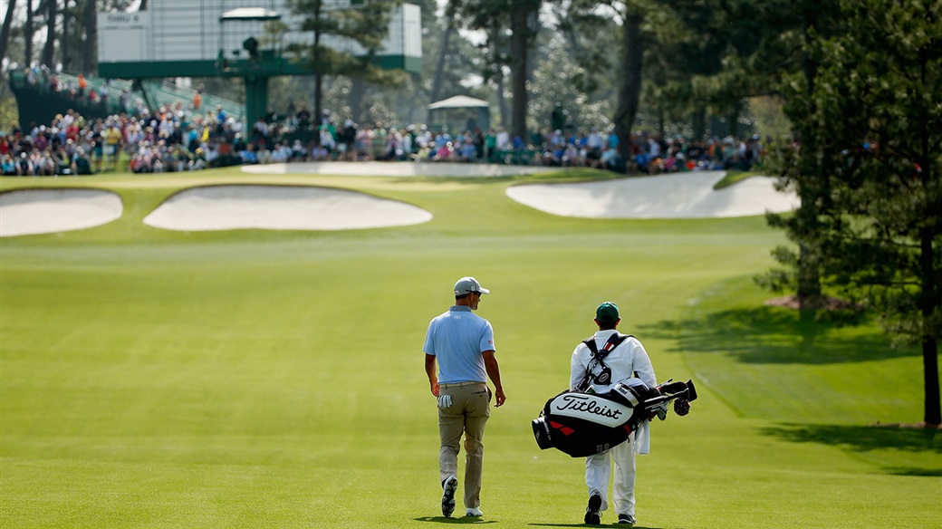 Adam Scott and his caddie walking the fairways of Augusta National Glf Club during action at The Masters