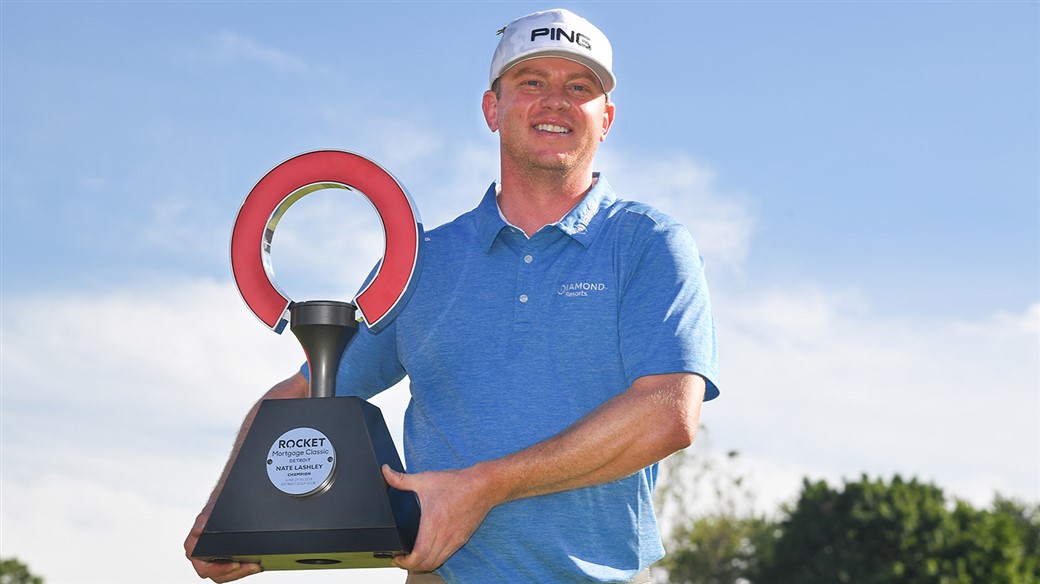 Nate Lashley raises the winner's trophy at the PGA TOUR's Rocket Mortgage Classic